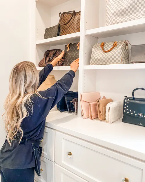 organizer placing purses on a shelf in a closet